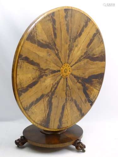 A mid / late 19thC tilt top breakfast table with circular top having marquetry detailing to the