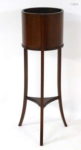 A 19thC mahogany jardiniere with three splayed legs and a shaped lower tier.