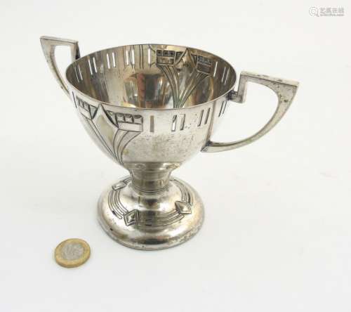 WMF A twin handled silver plate pedestal trophy cup with embossed decoration.
