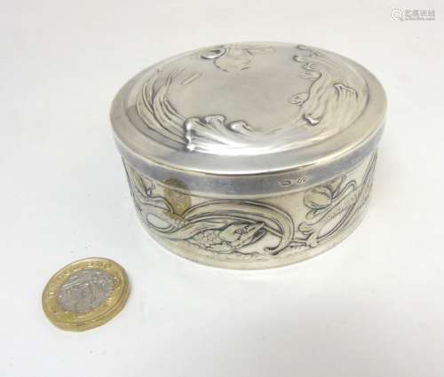 WMF : A bright silver finish embossed lidded pot decorated with scrolling fish decorated 3 1/4