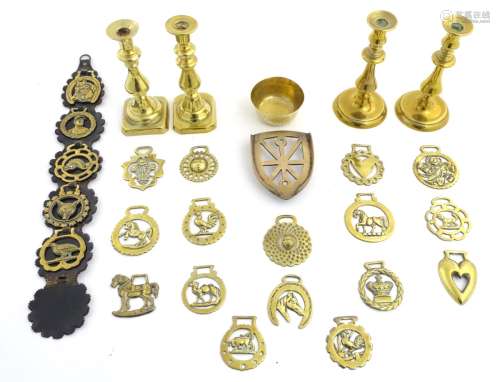 A box of assorted brass and bronze items to include candlesticks, trivets, bows, horse brasses etc.