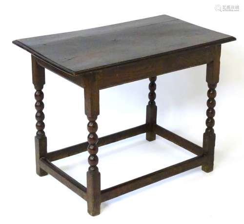 An 18thC elm topped centre table with thumb moulded edge,