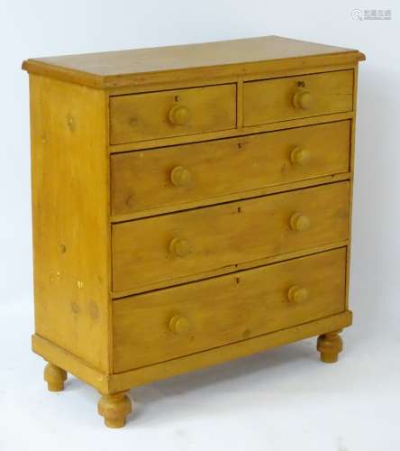 An early / mid 20thC pine chest of drawers with a rectangular moulded top above two short over