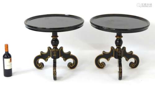 A pair of ebonised circular occasional tables with dished tops,