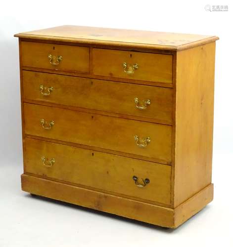 A Victorian stripped pine chest of drawers comprising two short over three long graduated drawers,