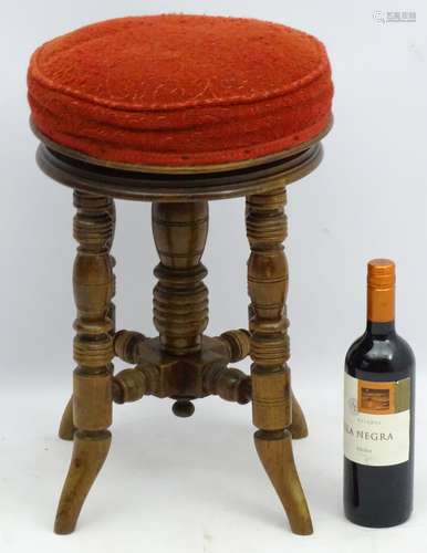 A Victorian mahogany piano stool standing on ring turned legs,