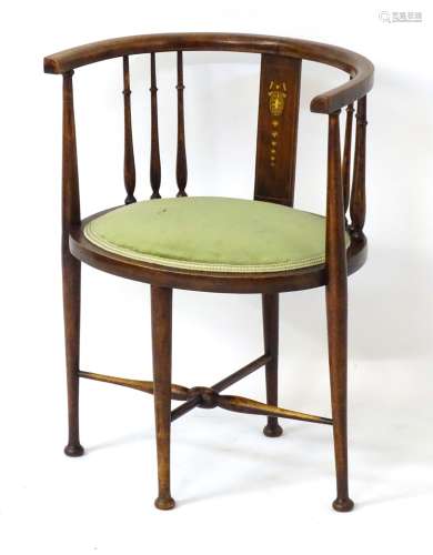 An early 20thC barrel back chair with turned slatted sides and marquetry detailing to the back