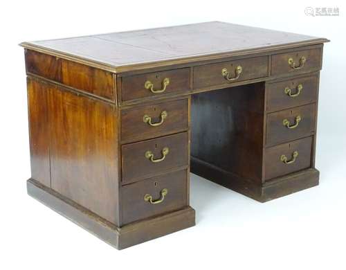 A mid 19thC mahogany double pedestal desk with a gold tooled leather inset top,