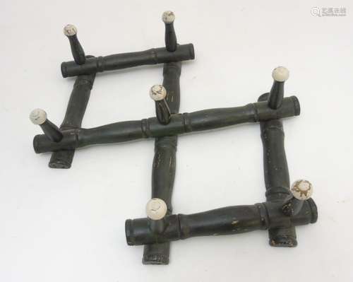 A set of expanding Victorian coat hooks with wall mount eyelets. With 7 pegs.