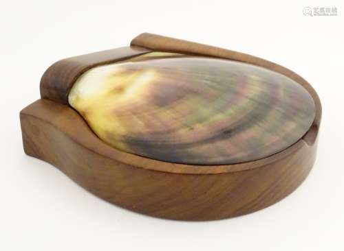 A mahogany trinket box with a large polished mother-of-pearl, scallop-shaped shell lid.