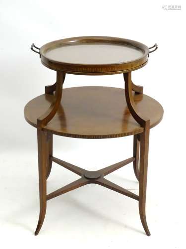 An early 20thC mahogany tray top occasional table with circular top and checkered inlay,