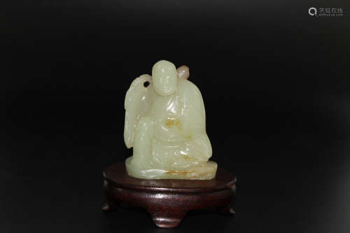 Chinese carved jade child holding peaches.