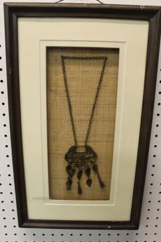 Framed Chinese necklace with pendant.