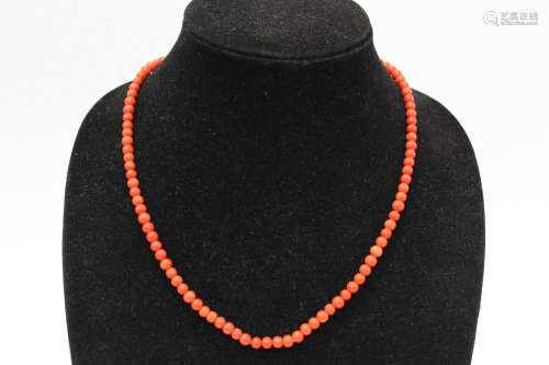 Red coral beads necklace.