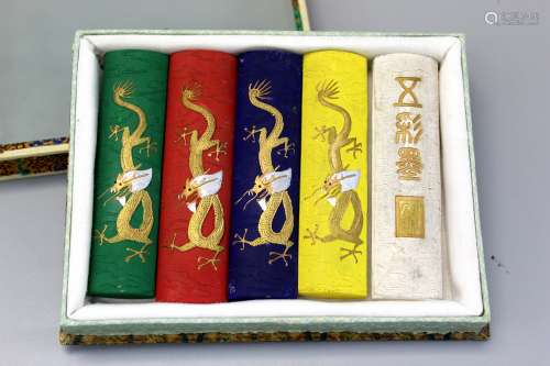 Box of five Chinese ink sticks with dragon decoration.