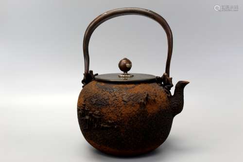 Japanese iron teapot with silver inlaid handle.