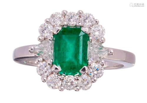 White gold ring set in the middle with an emerald ...