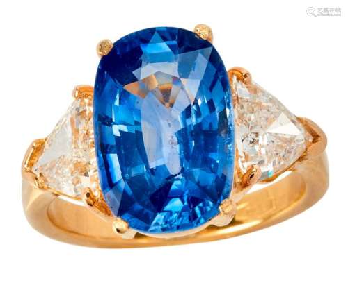 Yellow gold ring set with an oval sapphire weighin...