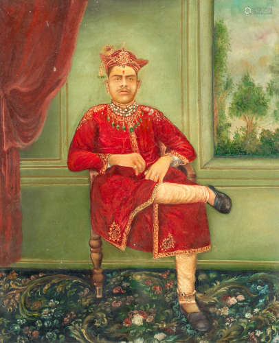 Portrait of a unidentified Maharaja wearing an elaborate emerald necklace, full length seated in a studio setting (Western carpet, panelled wooden walls with inset painted view, and red curtain), [early twentieth century] PRINCELY RULER