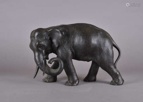 A Japanese Meiji period bronze, modelled as an elephant standing, character mark to underside, 23 cm