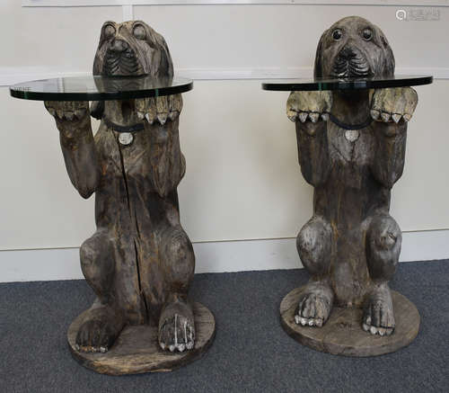 A large pair of carved wooden console tables modelled as begging dogs, glass circular tables, 112 cm