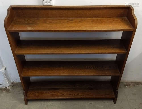 A 20th Century oak open backed bookcase, four shelves, shaped sides, 100 cm wide x 21.5 cm deep x