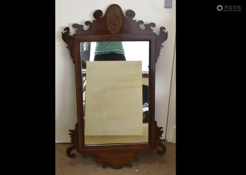 An Edwardian mahogany and chequered strung inlaid fret carved mirror, with oval inlay of Grecian