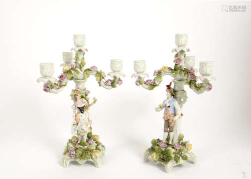 A pair of late 19th Century Bavarian porcelain candlesticks, three branch four lights, floral