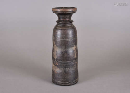 An Afghan wooden tribal flask, cylindrical form, incised decoration and cork stopper, 26.8 cm high