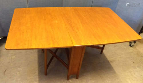 A 1970s teak drop-leaf dining table by A. H. McIntosh and Co, with label, 149 cm wide x 92 cm deep x