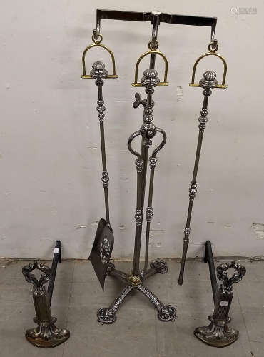 A modern set of steel and brass fire irons, comprising tongs, poker and shovel, on adjustable stand.