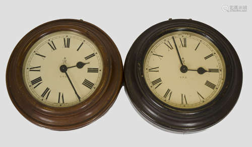 Two George V GPO wall clocks, slave movements, circular dials, Roman numerals, each 28.5 cm