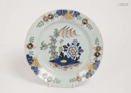 An English Delft poly chrome chinoiserie plate,circa 1760, painted with flowers and a mountain