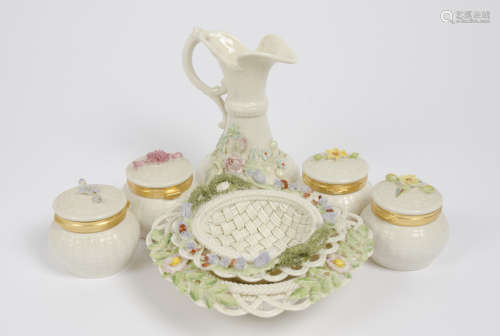 A group of floral encrusted Belleek porcelain, comprising four 'Flowers of the Month' pots, two