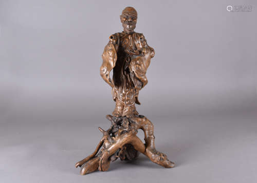 A 19th Century Chinese root carving, of elder depicted standing with left hand open and right hand