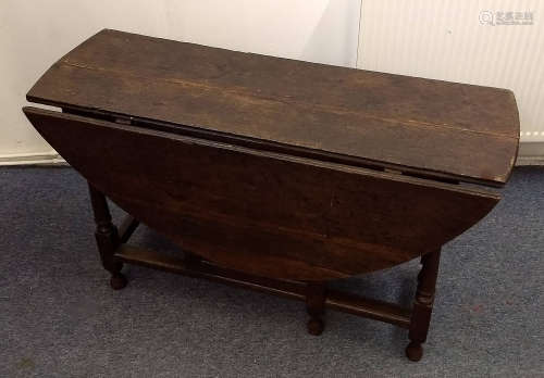 An 18th Century oak oval gate-leg table, turned and squared supports, 126 cm wide x 116 cm deep x 68