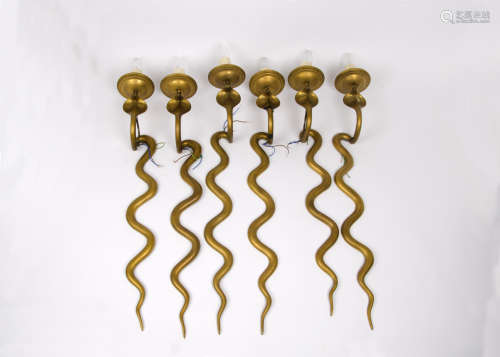 A set of six brass serpentine wall lights, 70 cm high. Together with a brass ceiling light with