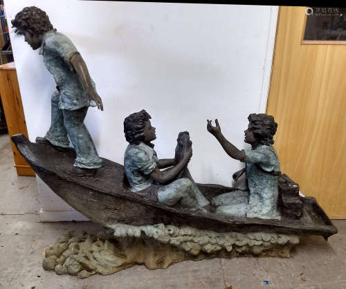 A contemporary bronzed garden sculpture of three boys in a fishing boat, indistinctly signed and