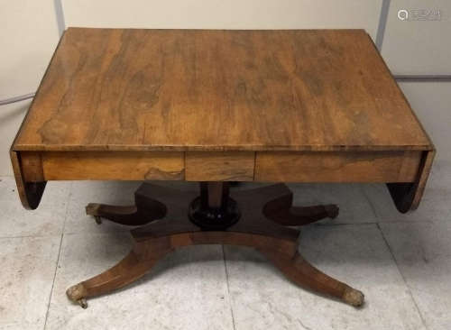 A Regency rosewood sofa table, four drawers, quadraform base, lion paw feet with casters, 152 cm