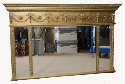 A modern Regency style gilt overmantle mirror, three bevelled glass plates, below swag and rosette