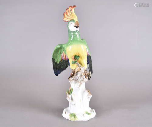 A 19th Century Volkstedt porcelain model of a parrot, depicted upon naturalistic base, coloured in
