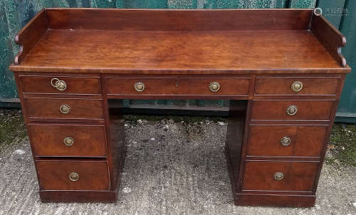 A 19th Century mahogany kneehole desk, one long drawer flanked by four graduated short drawers, a