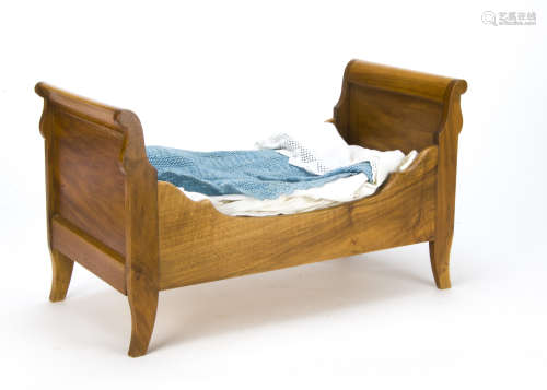 A doll's sleigh bed, with bedding, second half of the 20th Century, 52.5 cm high