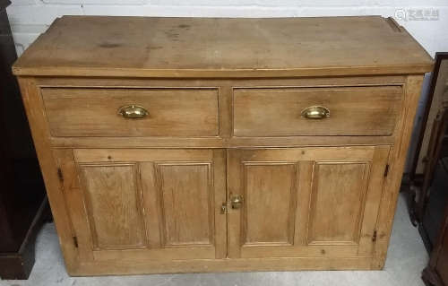 A 19th Century waxed pine dresser base, two short drawers over two panel doors, 131 cm wide x 51