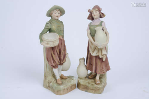 Two Royal Dux Bohemia figures, one of a girl carrying a jug, marked no 984, the other of a boy