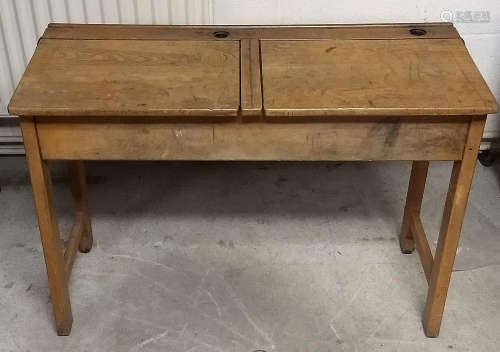 A vintage oak double school desk, two lift-up lids and inkwell holes, 102 cm x 43 cm x 72 cm