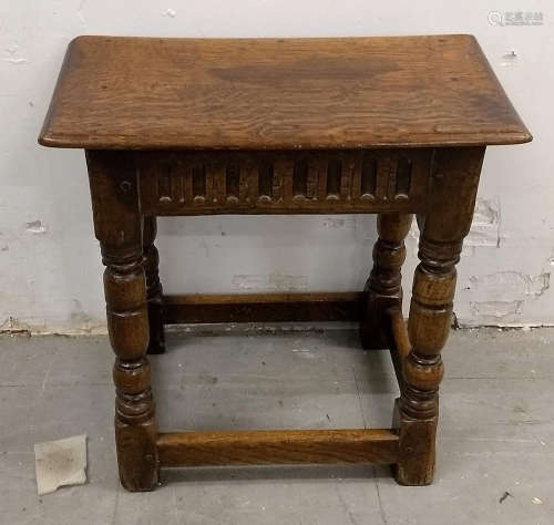 An 18th Century carved oak joint stool, turned supports united by stretchers, 44 cm high