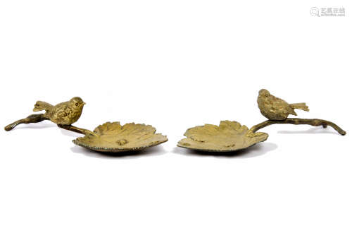 Two gilded metal birds, each perched on a leaf, 23 cm long (2)