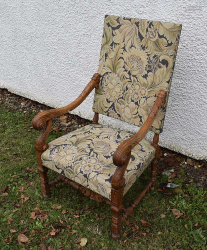 A 19th Century oak framed carved open armchair, floral seat and back