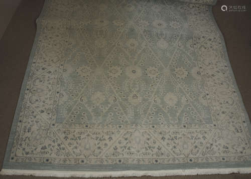 A modern woollen Turkish rug, cream scroll decoration on blue ground, cream border, 200 cm x 300 cm